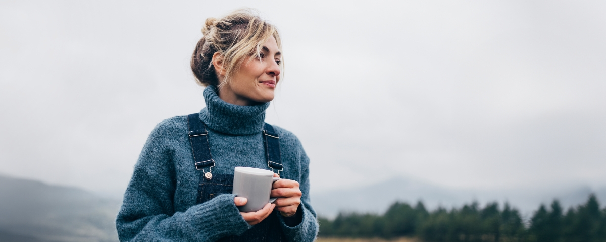 Women looking into future holding coffee